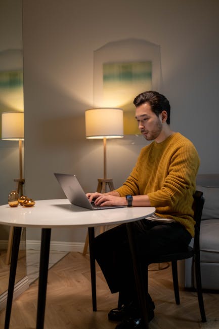 Man working on a laptop with a calm and focused expression