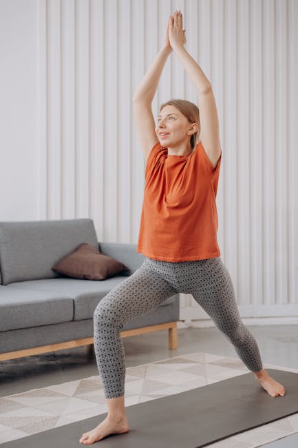 Woman practicing yoga pose indoors in a beautifully lit room